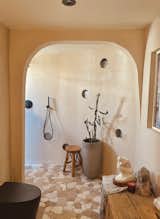 Inspired by a trip to a resort in Mexico, the walk-in shower has tadelakt plaster by Color Atelier in the color 'Nue.' The heated floors have flagstone in Jumbo Komodo Beige Honed Marble Mosaic Tile from Tile Bar.