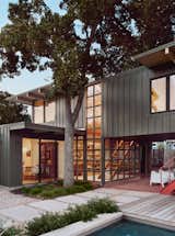 The windowed stairwell glows at night.