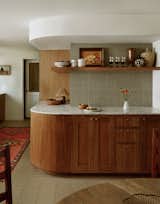 About this part of the kitchen, Chanel says, "We just had a fun with the radius corners in this space. Functionally speaking, we are rounding that corner a hundred times a day, so it's great for running children or clumsy people like me.