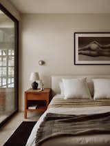 The bedroom has a bedframe from CB2.