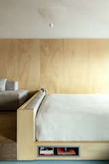 The bed has a niche for storing books.