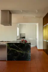 The sink anchors a wash station that's less in view of the rest of the home, letting dirty dishes be out of sight, and surrounding cabinetry holds less-used items. "We don't even have enough stuff for all that storage,