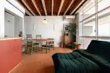 The red Formica tabletop is combined with a green powder-coated metal leg, which references the closet and bathroom doors. The pendant light and dining chairs are antiques, with the latter "matching the palette perfectly," says Stefany.