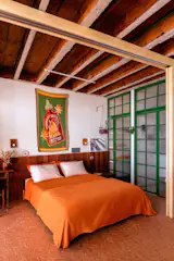 Custom metal doors with sidelites and transom windows, all made by VanMar Serralheria, were painted green, and one of the budget splurges for the project. "Our ‘luxury' were the metal doors in the bathroom and closet, with hand-picked glass that gives the apartment its charm,