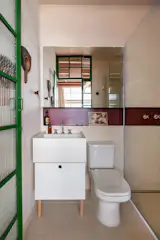 The wall tiles are the Olaria Collection by Lepri, paired with floor tiles in Dansk Cement by Portobello. The designers kept fixtures in place to save costs in the budget.