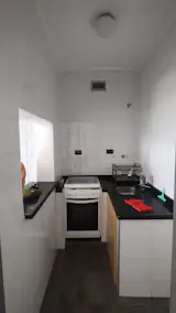 Before: The kitchen did not have enough storage, and despite a pass-through window, it felt disconnected from the rest of the apartment.