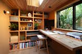 Repurposed Douglas fir (leftovers from concrete formwork from the house build) was used on the ceiling, with a Velux skylight. The custom Douglas Fir bookshelf was designed and fabricated by Kevin, with a desktop made from salvaged pine by Vintage Mill Werks and a Hay stool.