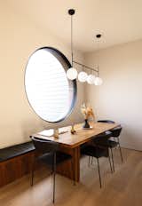 Kevin designed and fabricated the black walnut dining banquette. It sits with a ‘Corbett' table from Room & Board, Room & Board dining chairs, and a ‘TR Bulb Suspension Frame’ light by Tim Rundle.