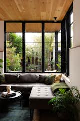 The sash-style windows are from Sierra Pacific, with a ‘Paramount’ sofa and ottoman by Blu Dot tucked underneath.