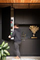 Black Ikea cabinets and a leather honed black quartz countertop convey a moody vibe.