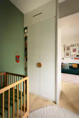 ‘Adirondack Green’ by Benjamin Moore covers the walls, with a built-in Ikea wardrobe.