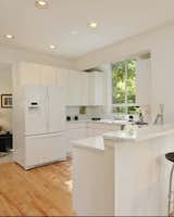 Before: There’s a glimpse of the office behind the kitchen. SHED removed the wall between the two rooms to enlarge the kitchen, and cleaned up the soffits, which were concealing old HVAC systems, to create a continuous ceiling plane.