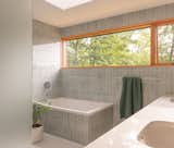 The wall tile is by Fireclay, in Hood River Gloss, and the floor tile is by Daltile, Outlander in Marine.