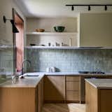 The backsplash is covered in G120 Lemon Ice tile by Heath Ceramics.