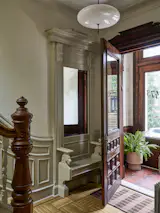 Architect Themis Haralabides of the design-build studio reBuild Workshop helped the new owners of this landmarked 1897 brownstone in Brooklyn’s Park Slope Historic District on a top-to-bottom remodel. The original parquet floors, entry bench, and door were saved.