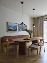 The casual dining area has custom banquette seating by H&amp;A Upholstery, with Moller Model 77 Side Chairs by J.L.Møllers Møbelfabrik from Design within Reach and an Arundel Pendant by In Common With.