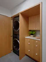 The laundry room has custom cabinetry by Big Branch Woodworking.