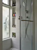 Zia Tile in 4x4 Alpha White covers the shower walls.