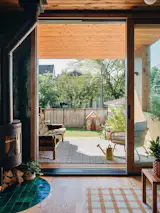 A covered porch is set under the second-floor addition, and gives the family a lot more access to the backyard. "The kids play outside, and can run inside, and we'll make up a little meal to eat and sit out on the porch,