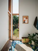 The mudroom is now on grade with the backyard, and the double-height ceiling creates a light box effect into the floors above and below.