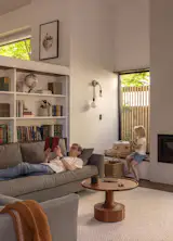 The sofa is the Hastings Sectional Sofa by Rejuvenation, with Turn Tall Side and Coffee Tables in Wood by Blue Dot, and, for a reading light, the Simone Double Sconce in True Black by Schoolhouse.