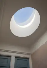 The new skylight looks like it was carved from the ceiling, to echo the downstairs fireplace treatment. The blue color is Benjamin Moore's "Polaris Blue."