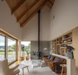 In the living room, the ceiling stretches to 24 feet tall at the peak. Select Alder was used throughout for casework, doors, windows (interior finish), and trim.