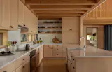 In the kitchen, there's Alder cabinets topped with Ceaserstone counters. The Miele induction cooktop was placed over a Miele Clean Touch Steam Oven.