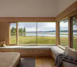The primary bedroom has an extra-long window seat made of Alder wood.