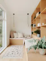 In the library in the primary suite, big windows create a tree house effect. The pendant is a Pigeon Toe Ceramics X Rejuvenation model.