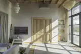 The bathroom is split into a shower and sink room on the left, and a toilet room on the right, behind tall antique doors bought in Belgium.