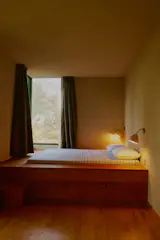 The architects maximized the small space in a lower bedroom with a built-in bed with storage underneath. The Oak parquet flooring was chosen to echo the main house finishes.