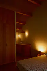 The upstairs bedroom has the same wood, Beech stained with a cinnamon-colored oil, for the sink vanity, and vaulted ceilings.