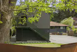 Staircase, Metal Tread, and Metal Railing A metal staircase painted forest green hints at the ADU’s colorful interior. The offset gable roof was designed so solar panels can be installed in the future.