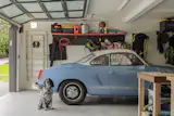Garage, Garage Conversion Room Type, Storage Room Type, and Detached Garage Room Type The couple's dog, Zuzz, enjoys the new room to roam.