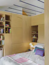Storage Room, Closet Storage Type, Cabinet Storage Type, and Shelves Storage Type The U-shaped cabinetry that surrounds the bed packs in storage on both sides for everything from books and vinyl to clothes and cleaning supplies.