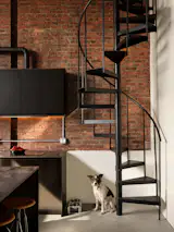 Luna poses in front of the newly revealed staircase. "My main goal for this was to bring it to its roots as much as I could, and honor the legacy of the building,
