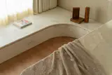 There is drawer storage in the base of the window seat for linens.