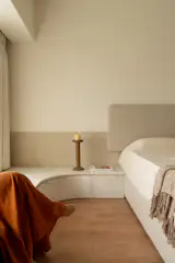 A curving window seat made of locally-sourced marble flanks one side of the room.