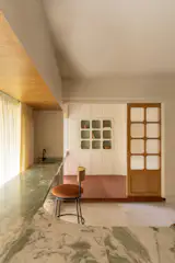 The study has floors covered in local terra-cotta bricks, and custom oak sliding doors. The couple will open the room up to the rest of the home if they're having a large party.