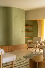 The door to the powder room is inset into the wall, and the slatted wood treatment running along the base extends to the storage on both sides.