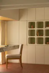 The cabinetry hides away Nikita's book collection, and she uses the open shelves to curate different displays.