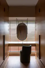 To the left of the vanity is a door into the primary bathroom.