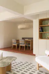 The dining room also has the locally-sourced terra-cotta flooring with a Polo Pendant Light from Name Place Animal Thing above the custom table, designed by Kaviar Collaborative.