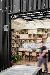 The exterior siding is Western States Metal Roofing, in matte midnight black. "Metal siding harkens to the old warehouse quality of the space,