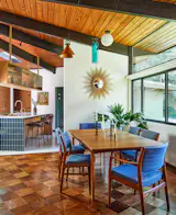 In the dining room, Lauren purchased the vintage table and chairs, and a Vakkerlight chandelier hangs above them.