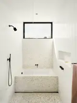 The plumbing fixtures are from VOLA and the tile is terrazzo from Concrete Collaborative.