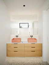In the bathroom, the vanity has concrete sinks from Kast.