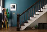 In the second floor entry, the original wood post, banister and balusters were restored. New floors, trim and windows were selected to match the existing throughout the home.