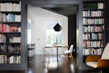 The living room opens to the dining and kitchen at the rear of the house, and looks straight through to the rear yard. The trim and bookcases that frame the opening match the existing features of the home.